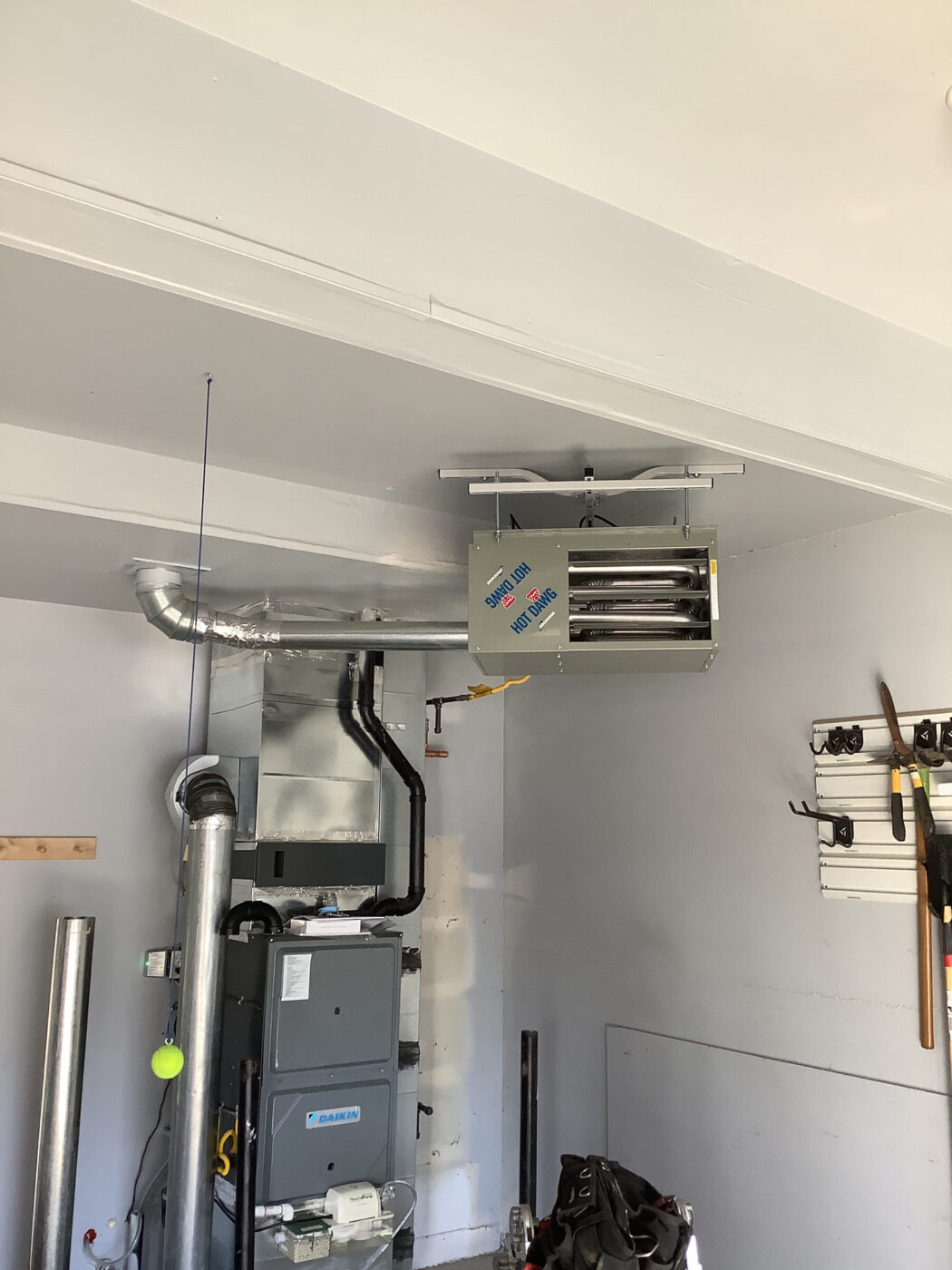 Modine garage unit heater alongside a Daikin forced air furnace