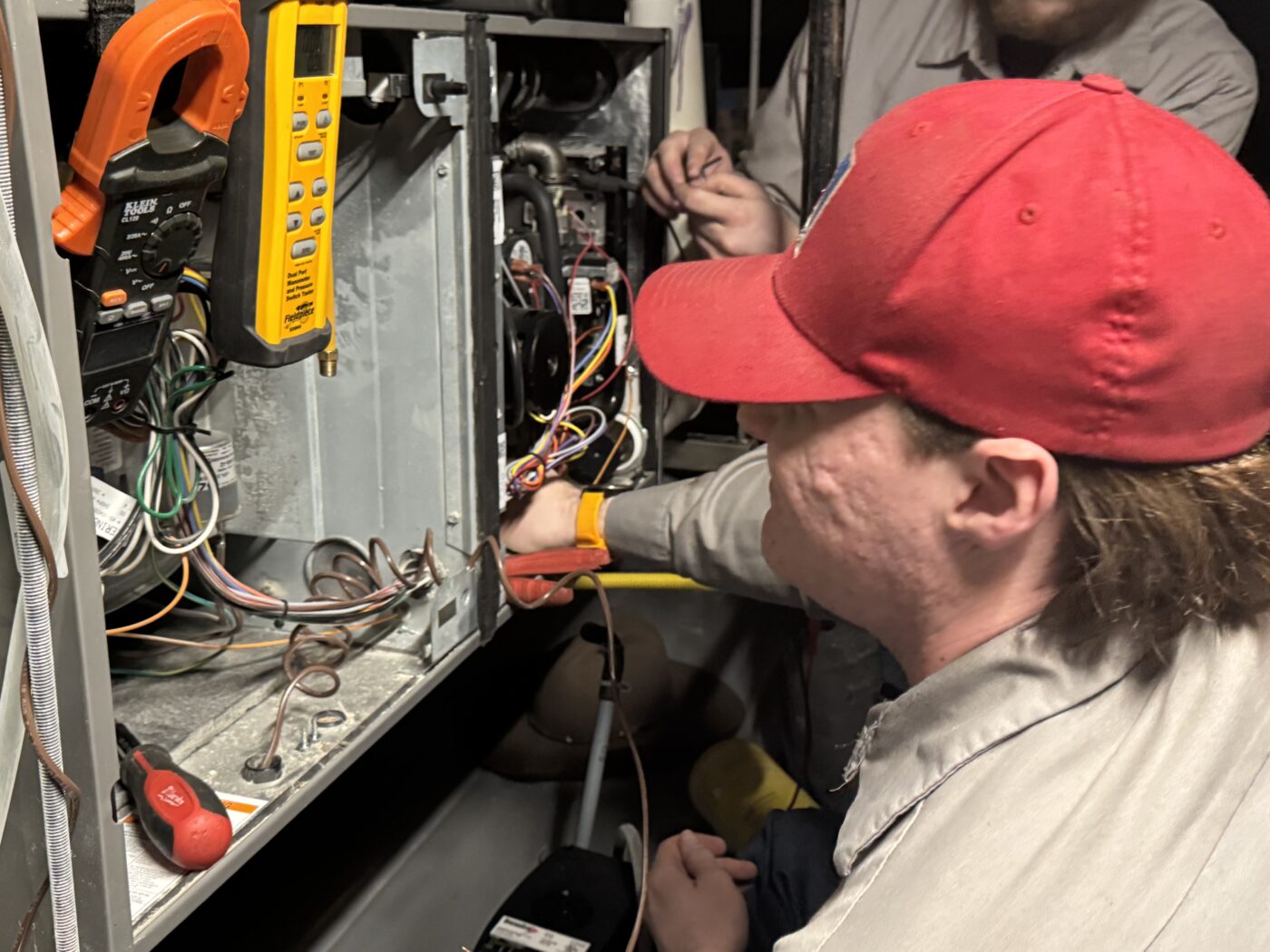 Knik Heating technician Jared servicing equipment on a job site